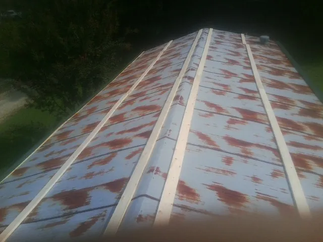 Rusted metal roof panels with new wood purlins before replacement — Storm Damage Roof Repair in Bethlehem by Roofing Brothers