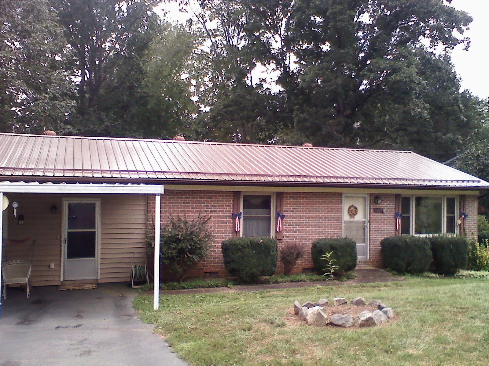 Bronze metal roof and carport on a brick ranch home — Roof Repair work by our crew in Bethlehem